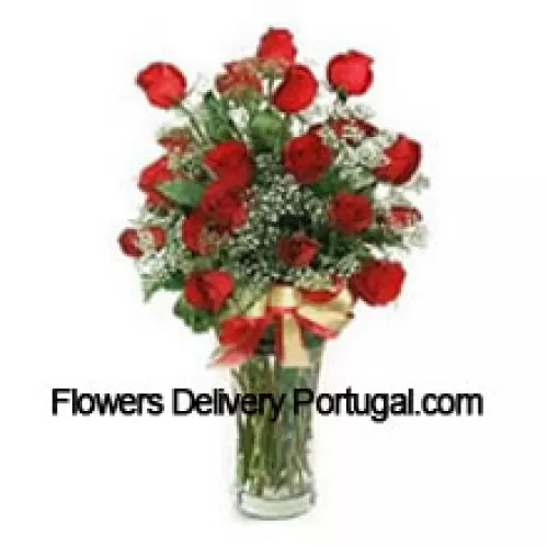 25 Red Roses With Some Ferns In A Glass Vase, A Cute Brown Teddy Bear And An Imported Box Of Chocolates